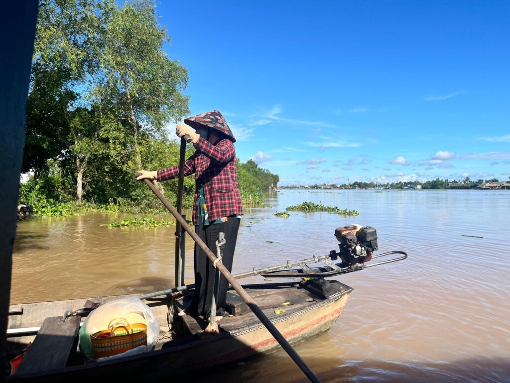 Woman rowing boat in Vietnam 