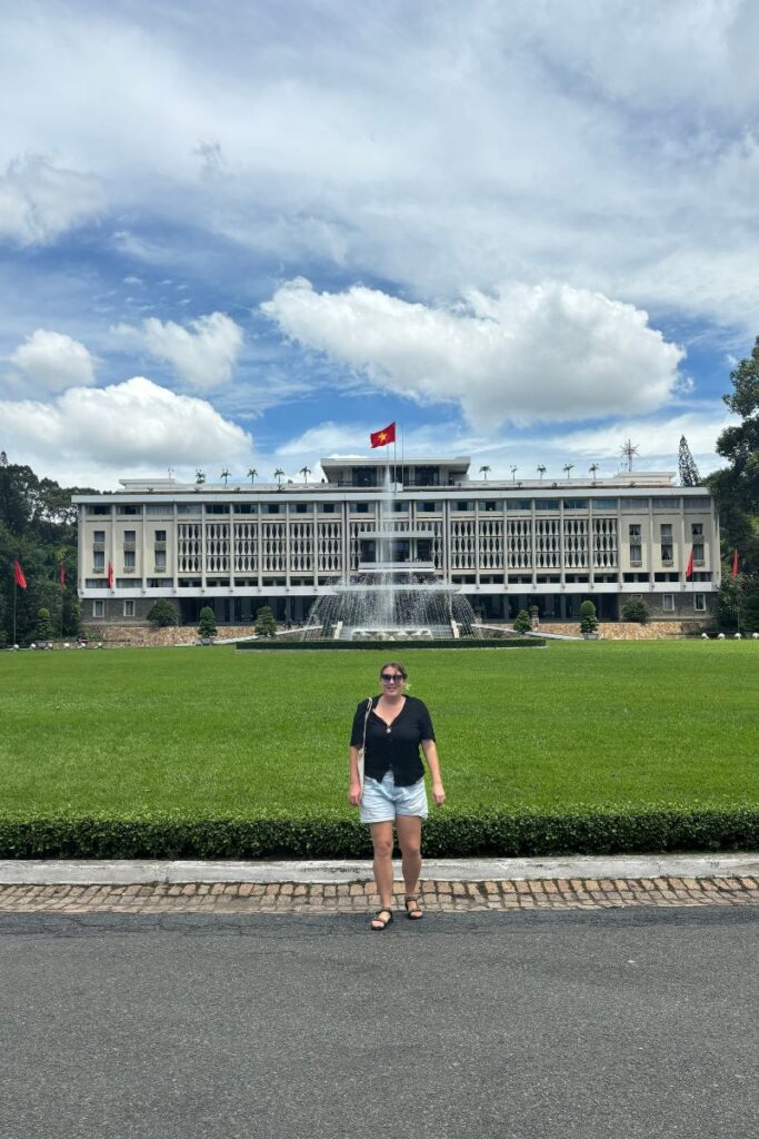 Standing outside the historic Independence Palace, a must-see landmark when exploring things to do in Ho Chi Minh City.