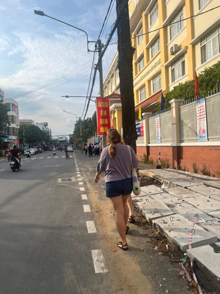 Megan walking with bag in Vietnam 