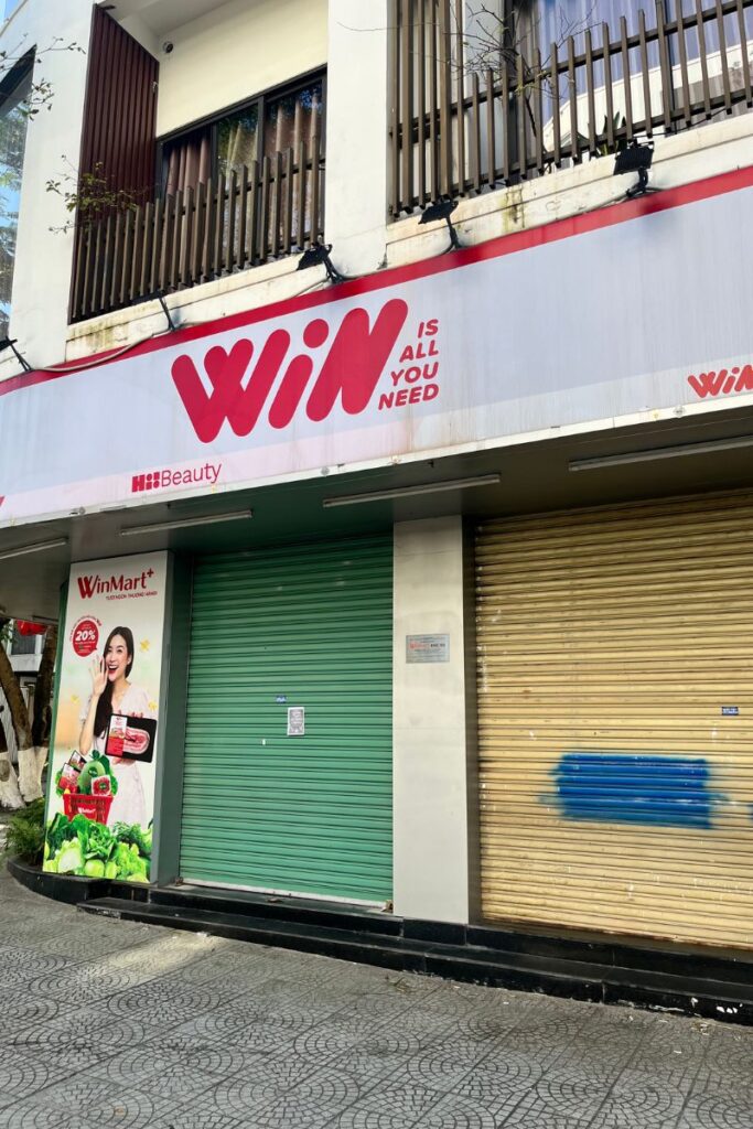 WinMart storefront in Ho Chi Minh City with metal shutters down during the Tet holiday, showing how many businesses close for the celebration.