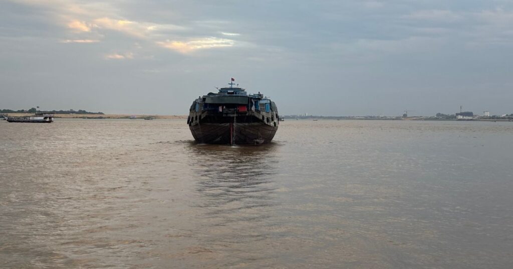 Solo boat floating down the Mekong River