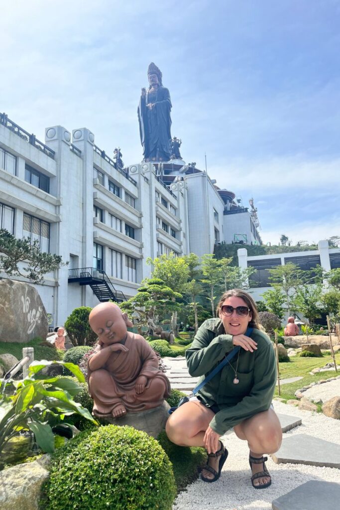 Megan next to Buddha statue at Black Virgin Mountain 
