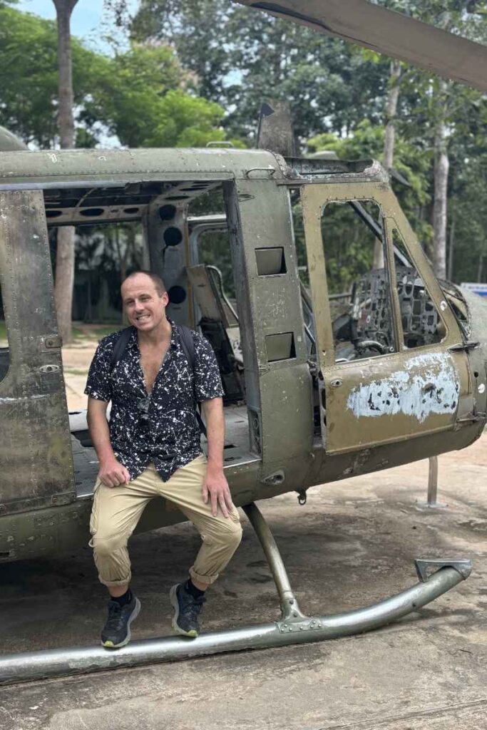 Garrett sits in a "Huey" helicopter at Cu Chi Tunnels 