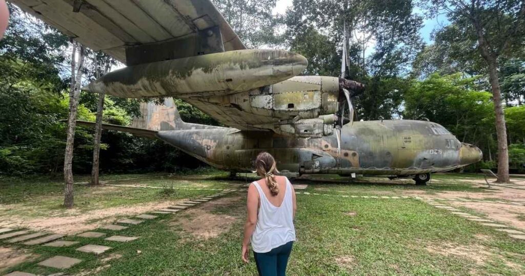 Megan stands near C-130 at Cu Chi Tunnels 