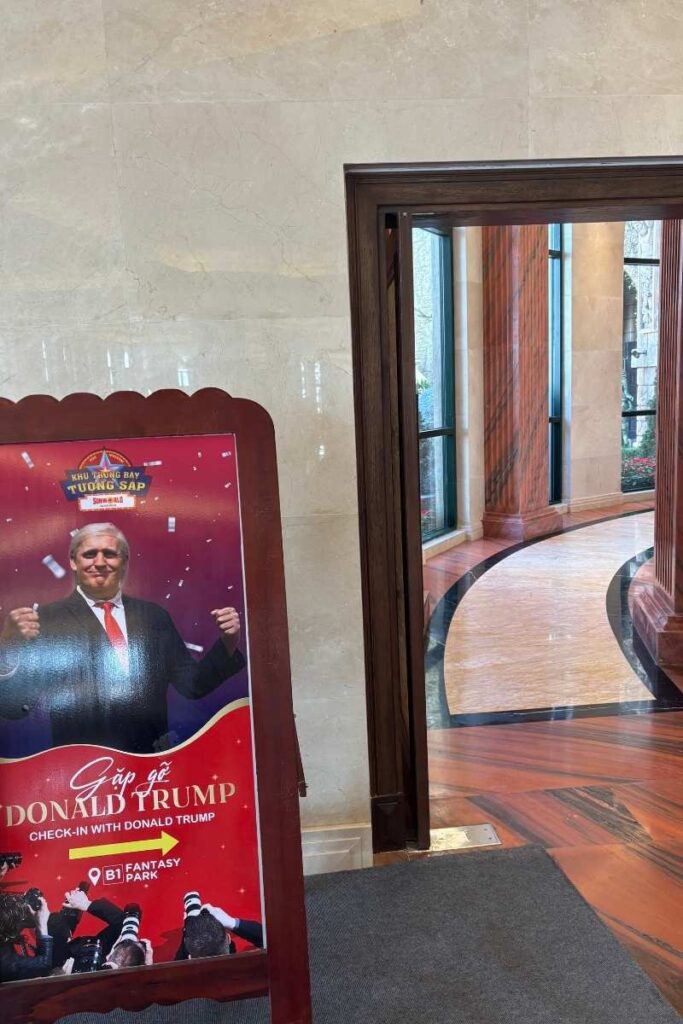 Entrance to the Wax Museum at Ba Na Hills, featuring a promotional standee of a Donald Trump wax figure and signage for Fantasy Park.