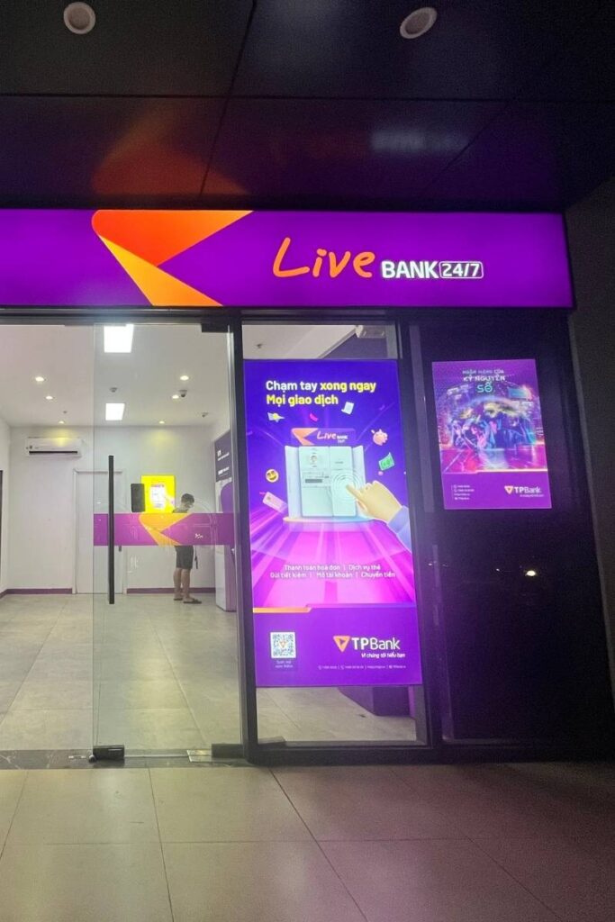 A brightly lit ATM booth in Vietnam, where tourists should be cautious of common ATM-related Vietnamese scams.