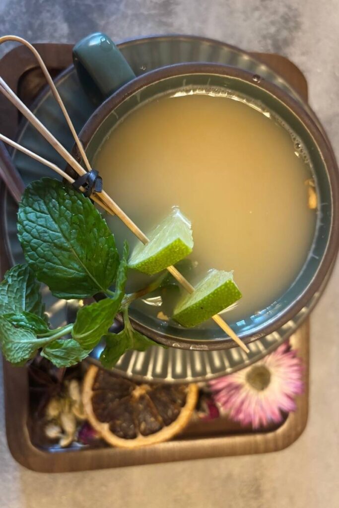 A traditional tray of ginger tea in Da Nang with lemongrass and fresh herbs, capturing a peaceful moment and a flavorful side of what to do in Da Nang for wellness lovers.