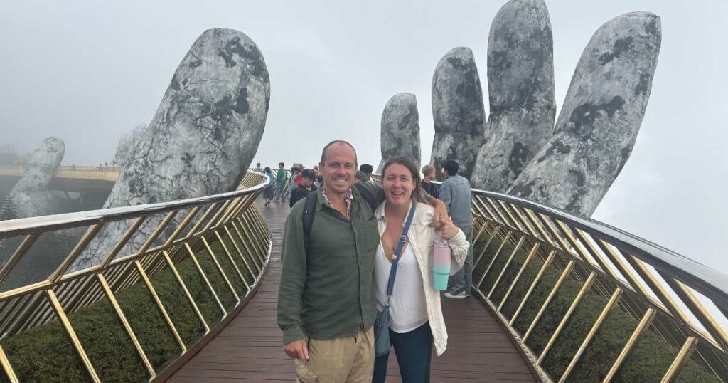 Posing on the Golden Bridge at Ba Na Hills near Da Nang, held up by giant stone hands and surrounded by mist — one of the most iconic sights to see near Da Nang.