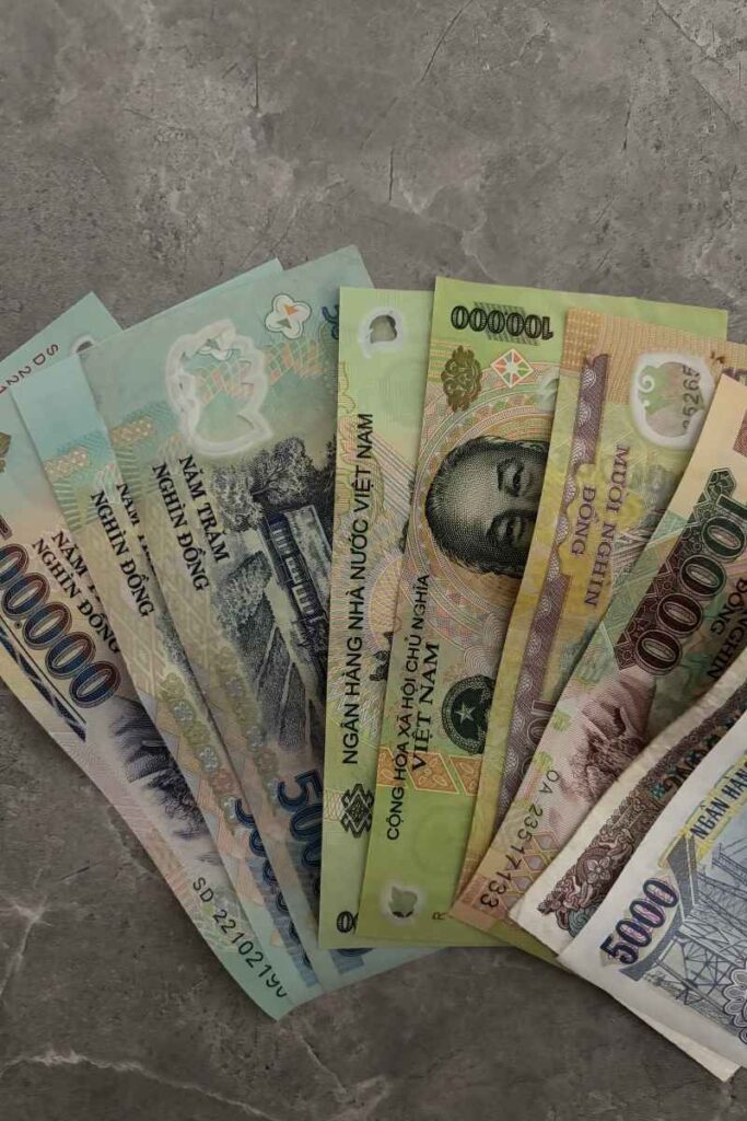 A fan of Vietnamese dong banknotes, often involved in common scams in Vietnam where tourists receive incorrect change.