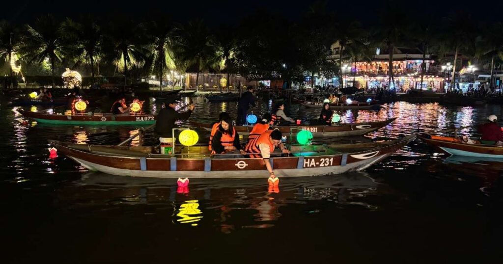 Lantern-lit boat floating on the river in Hoi An at night, a dreamy scene for travelers visiting from Da Nang and a favorite evening experience near the city.