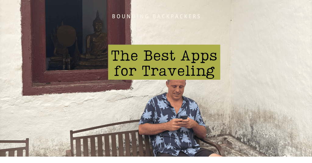 Graphic-style cover image with a green banner that reads “The Best Apps for Travel” pinned to a wall above a colorful world map and a small travel figure holding a suitcase.