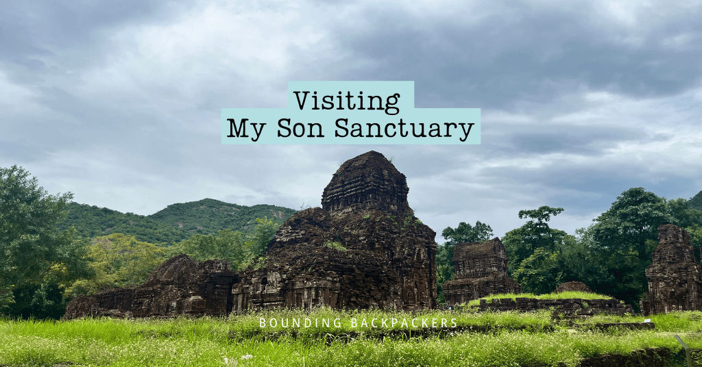 Cover image showing ancient brick temple ruins of My Son Sanctuary set against a backdrop of lush green hills and a cloudy sky, with overlaid text reading "Visiting My Son Sanctuary – Bounding Backpackers.